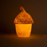 Glowing acorn-shaped lamp on a dark background
