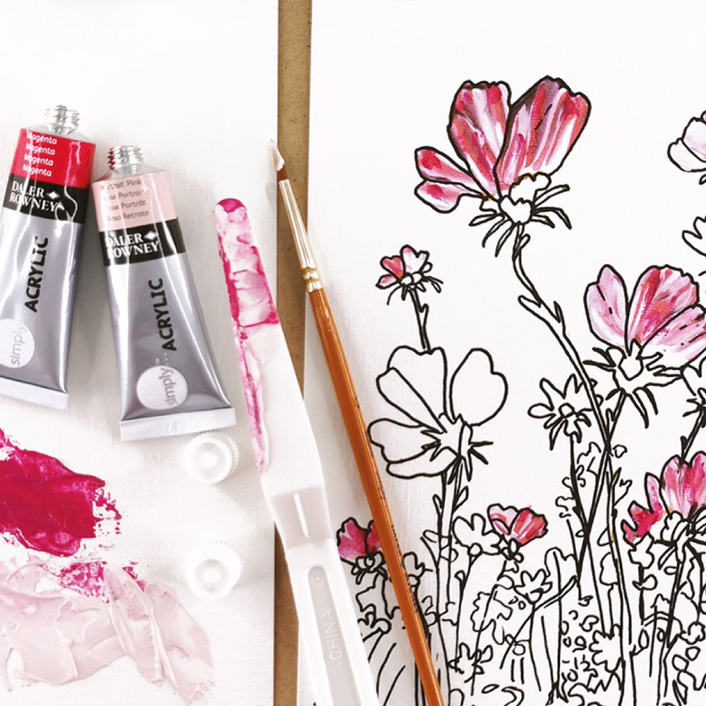 Acrylic paint tubes and a brush next to a floral drawing on a white background