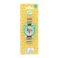 DJECO cat-shaped watch on a yellow patterned retail card, featuring a mint green cat face dial with white, orange, and black details, and a pastel multicolor strap.