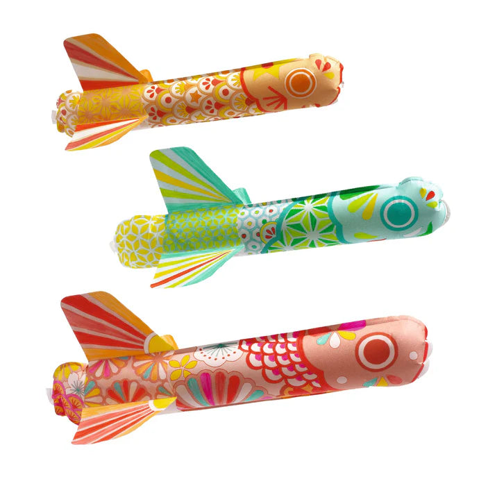 Three colorful toy planes with floral patterns on a white background